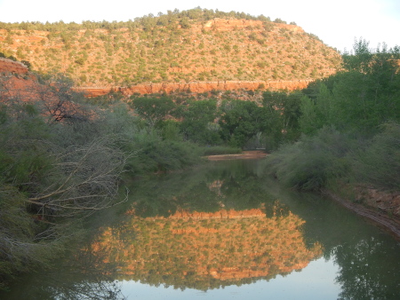 Reflection of valley walls on the river at sunset
