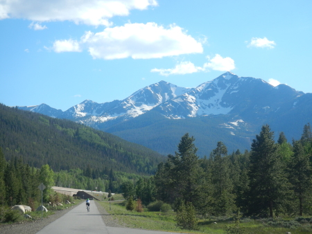 The mountains surrounding Frisco as a cyclist zooms past
