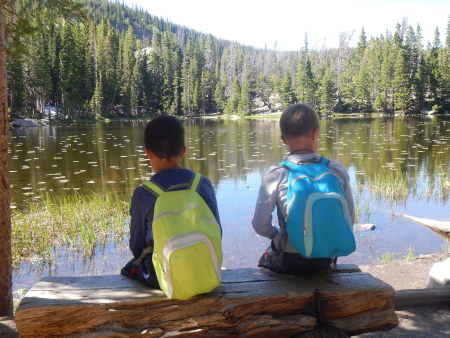 Enrique and Nicolás enjoying a rest next to Nymph lake in Rocky Mountain National Park