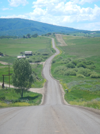 Road extends into the distance wiht curves and hills