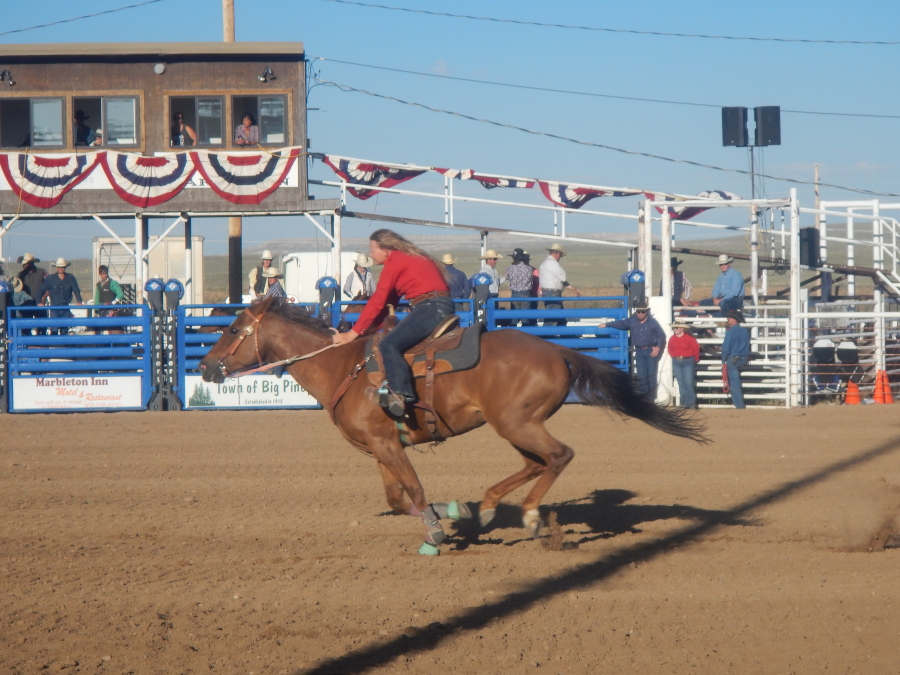 Cowgirls racing hard in the barrel race
