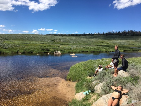 The whole team having a rest by the river after going for a swim