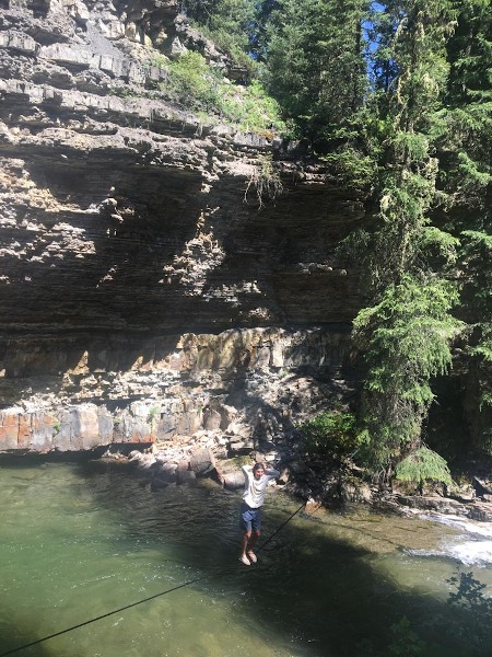 Jacob walking a water line over the river
