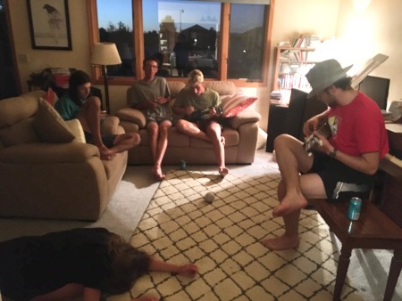 The team in Aiden's house playing the ukulele