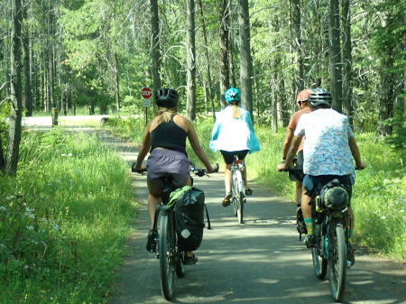 The entire Babe team on their bikes cycling along a cycle path in Glacier National Park