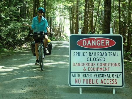 Naughty Ruth cycling past a danger, no access sign 