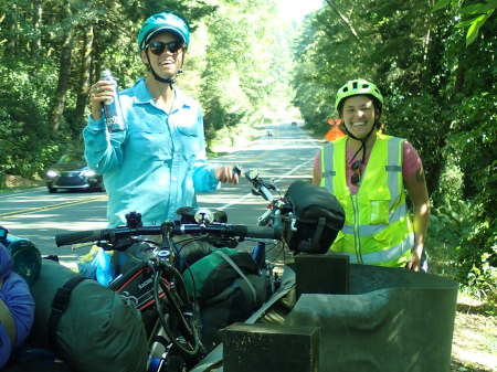 Ruth and Hannah Jo smiling on the side of the road soon after fixing a puncture