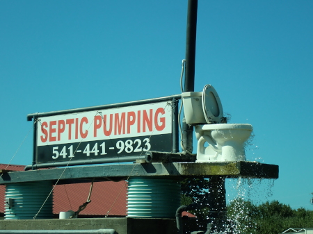 Sign for a septic pumping company with toilet water feature