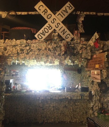 The dollar bills pinned to the walls of the bar in Oatman, an old mining tradition