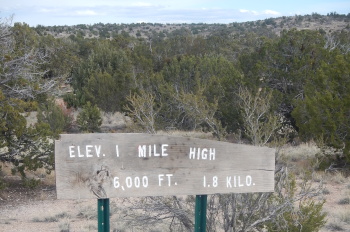 A sign stating our altitude of 1 mile