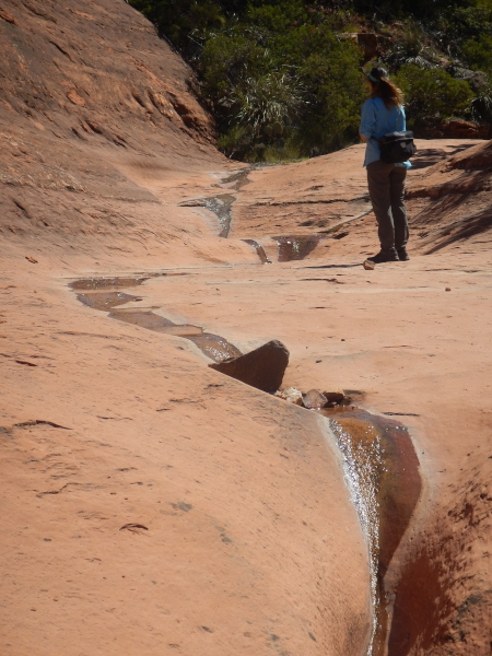 Ruth observing the smooth rocks in the wash