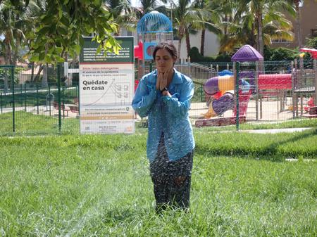 Ruth cooling off under the sprinklers in the park