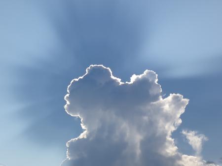 Large storm clouds blocking out the sun which is only apparent from the halo around the cloud