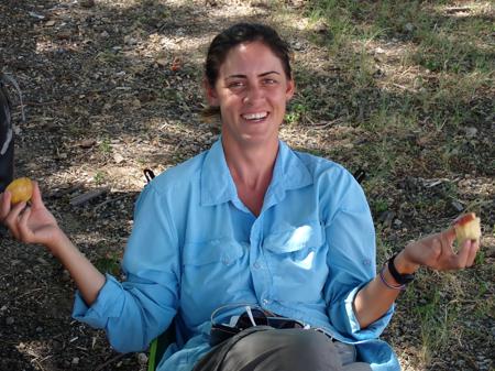 Ruth resting at the toll booth in the shade of a tree and eating fruit