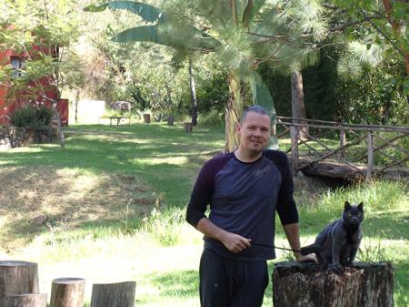Dennis walking one of the cats around the campsite so the birds of pray don't get their own back on the cat