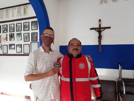 Rob receiving a present from Andrés while staying at the fire station in Irapuato