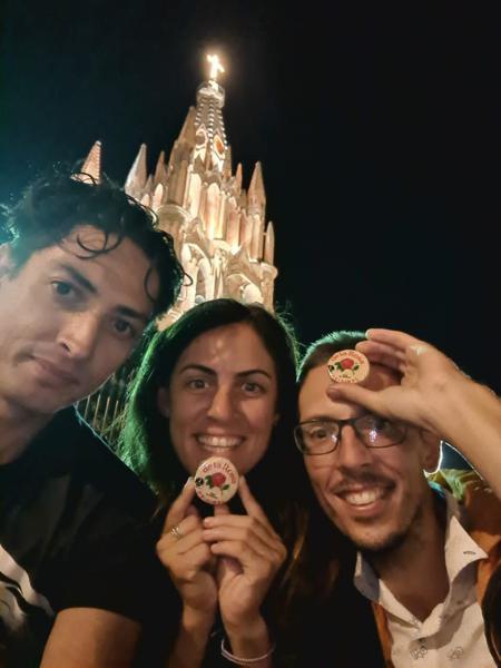 Ricardo, Ruth and Rob posing with marzipan 'la rosa' and the cathedral of San Miguel de Allende in the background