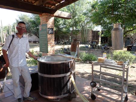 Rob posing next to a barrel where cheese is prepared