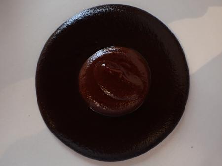 Dish with Mole Madre and a pool of freshly made mole in the middle