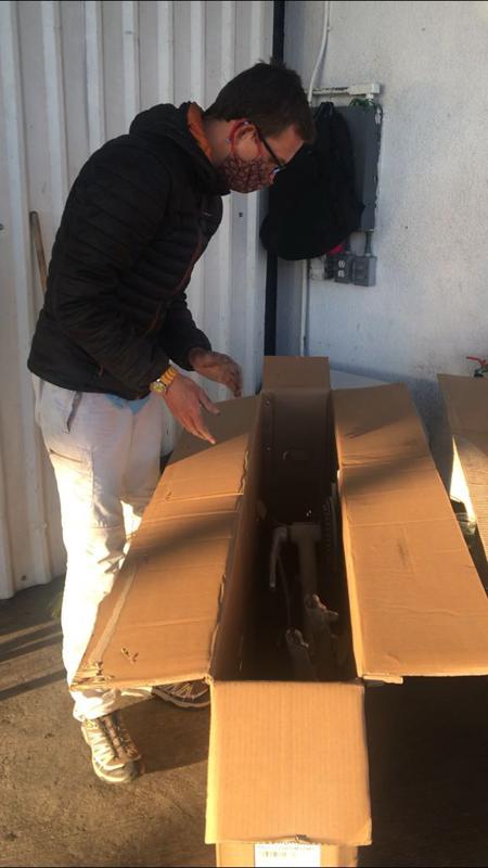 Rob on the car hire forecourt masked up and bike packed ready for the flight 